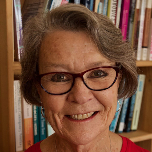 older women standing if front of a book shelf